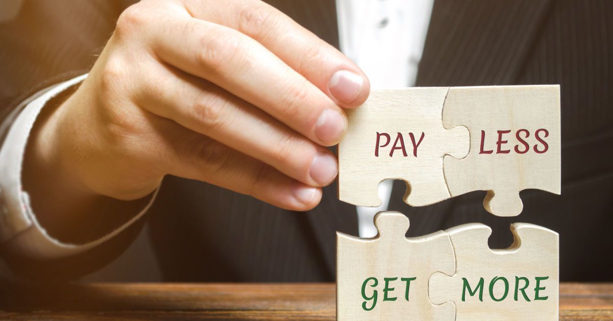 Businessman collects wooden puzzles with words Pay less get more