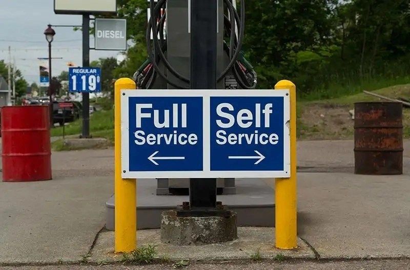 sign gas station instructing people