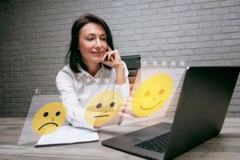 senior-business-woman-pressing-smiley-face-emoticon