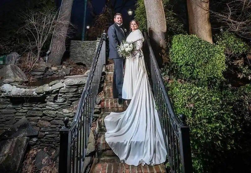 a man and woman in wedding attire on a bridge