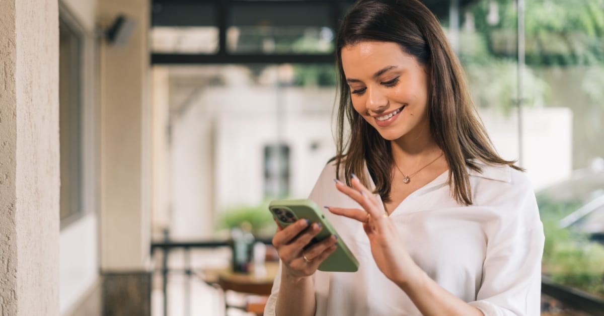 Happy and cheerful businesswoman using smartphones.