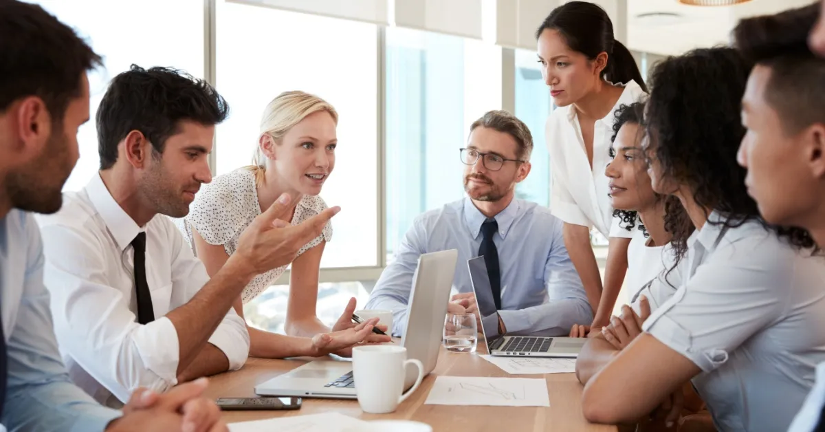 Group of people meeting around table in Office