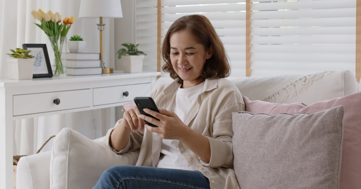 Old adult female sit relax and happy on sofa.