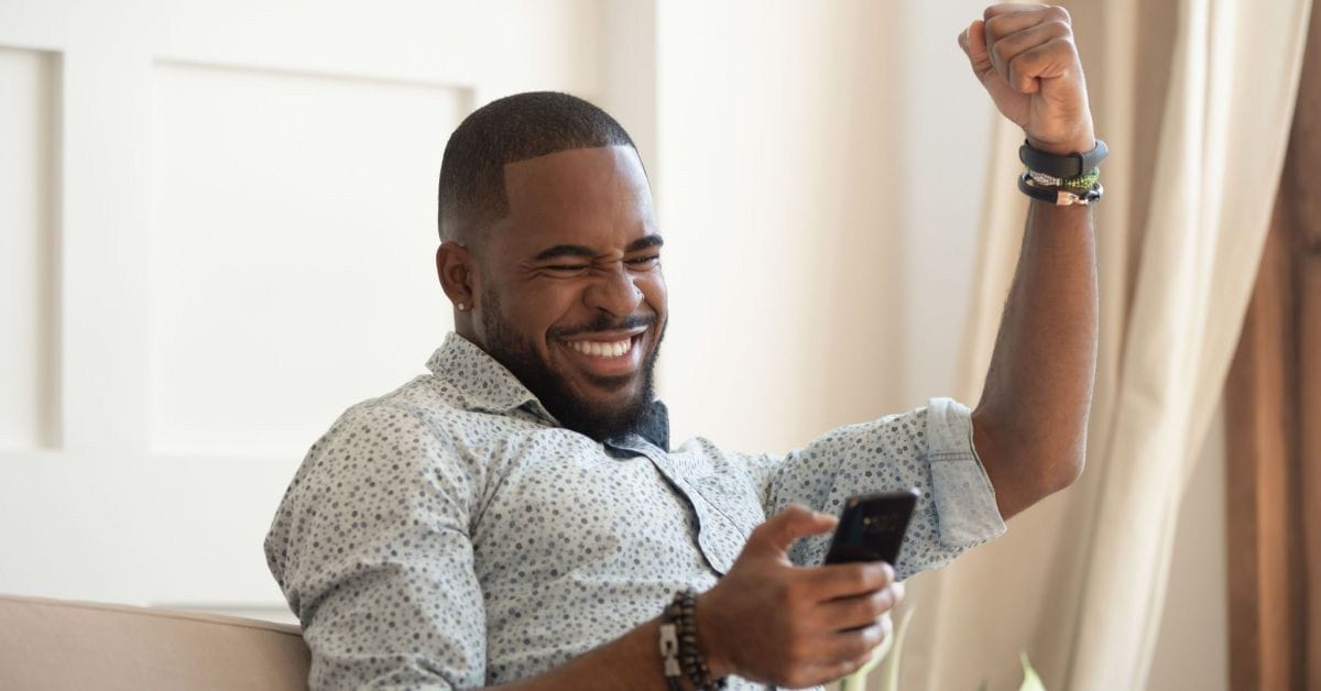 Excited overjoyed black man
