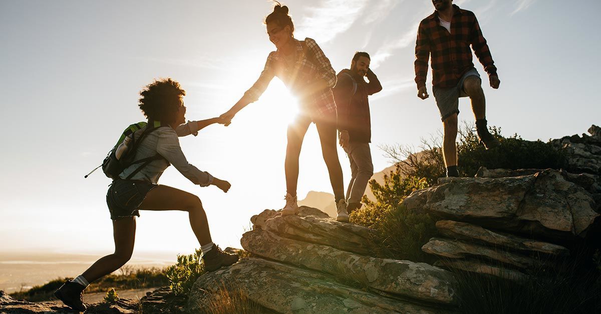 Group of people climbing a mountain