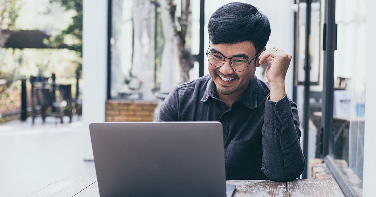 Man sitting outside using his laptop