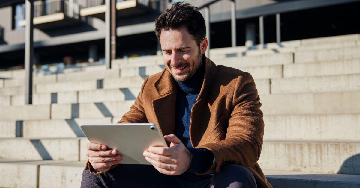 Man on his tablet, using voice of the customer - NiCE VOC application